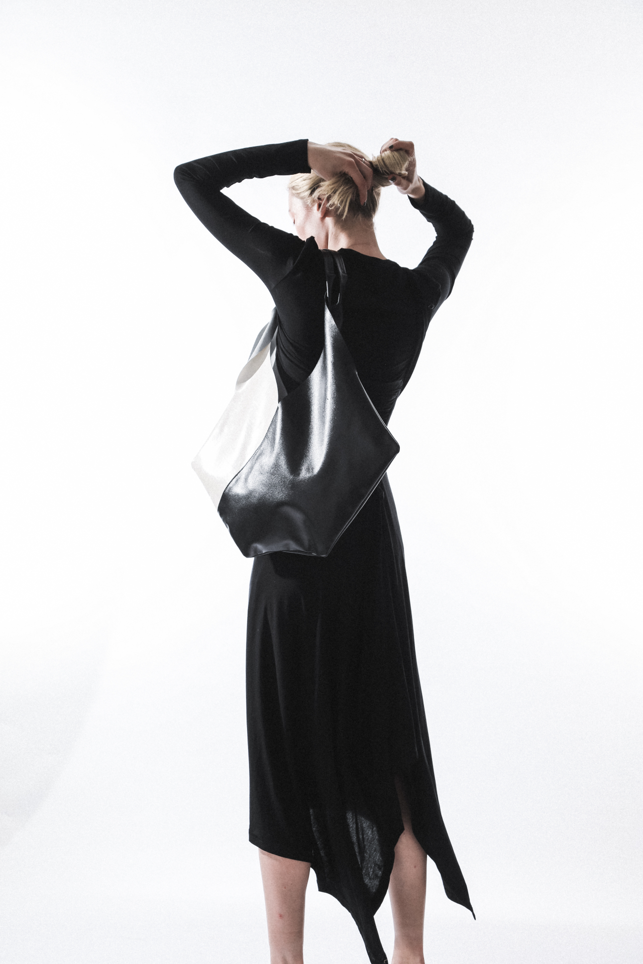 Model carrying a black oversized bag