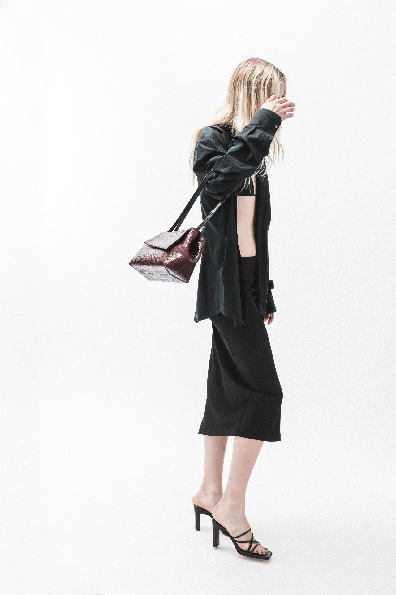 Model wearing a burgundy leather shoulder bag