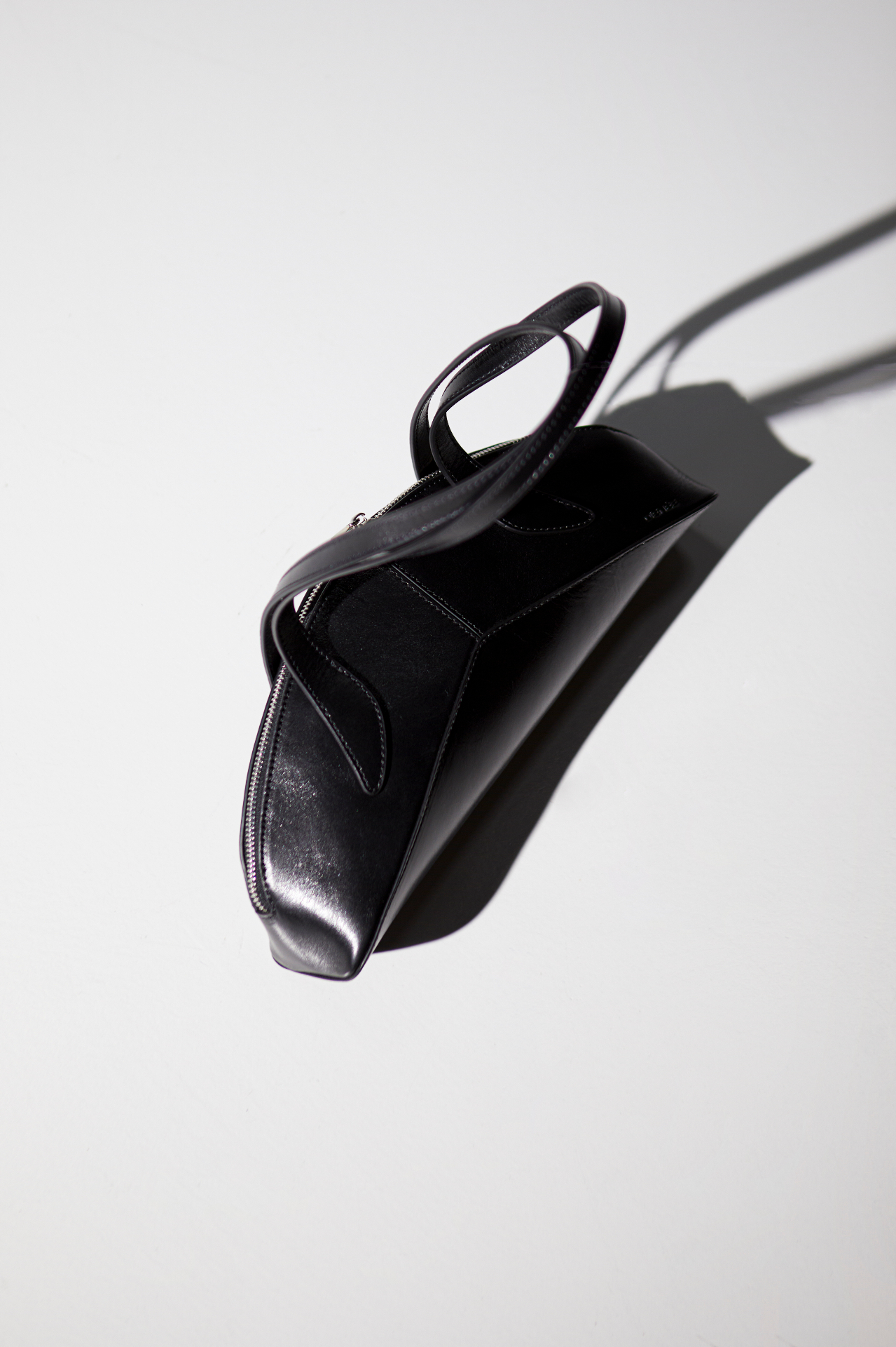 Black leather bag in studio light